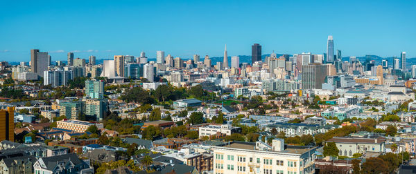 Cityscape against clear blue sky