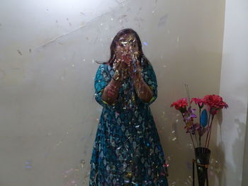 Woman with umbrella standing in water