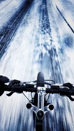 Close-up of bicycle on road against blurred background