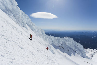 A man climbs down from the summit of mt. hood in oregon.