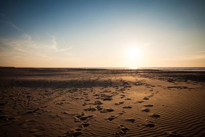 Scenic view of beach against sky during sunset