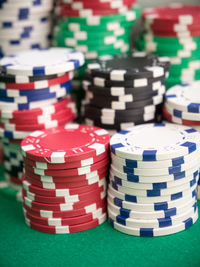 Close-up of stacked gambling chips on casino table