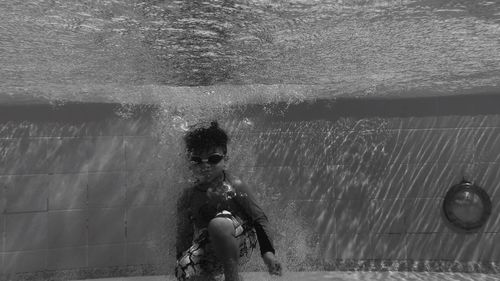 Portrait of boy swimming in pool