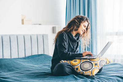 Young woman using laptop at home