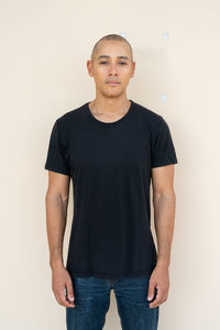 Portrait of man standing against white background