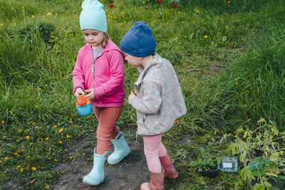 Children with a watering can go to fetch water to water seedlings. 