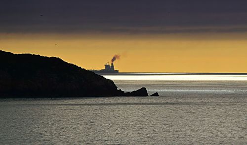 Scenic view of sea against sky at sunset