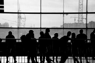 Silhouette people standing in modern building