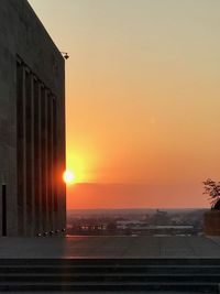 Scenic view of buildings against clear sky during sunset