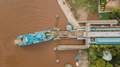 Hingh angle view from drone, showing us passenger ship dock in riversid of kapuas