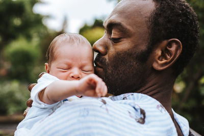 Portrait of father with baby outdoors