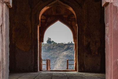 Andha ka mahal seen through arch door at mandu