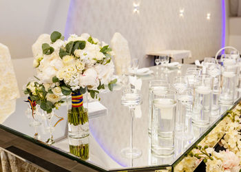 Wedding bouquet on a mirror table tricolor ribbon.