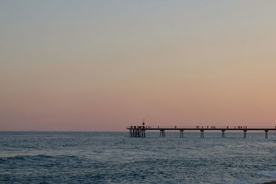 Scenic view of sea against clear sky during sunset