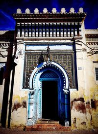 Low angle view of ornate building against blue sky