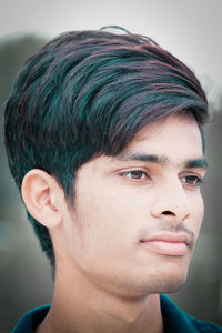 Close-up portrait of young man looking away