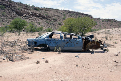 A wrecked junk car in the desert in africa