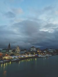River amidst buildings against sky in city