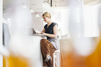 Woman using digital tablet in a cafe