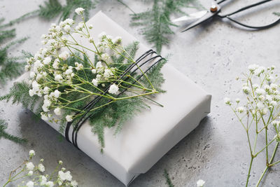 High angle view of flowers on gift at table