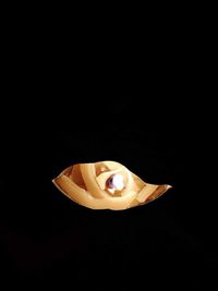 Close-up of illuminated lighting equipment against black background