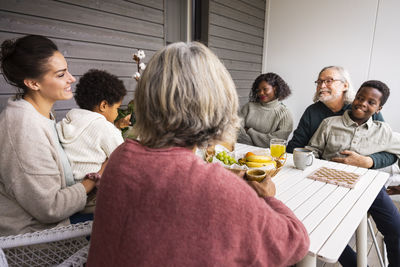 Family sitting at table outdoors