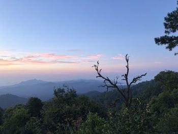 Scenic view of mountains against sky at sunset