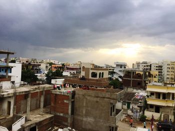 Buildings against cloudy sky