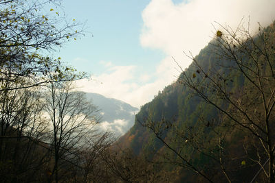 Scenic view of mountains against cloudy sky