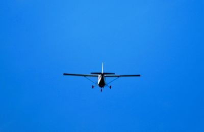 Low angle view of airplane flying in sky