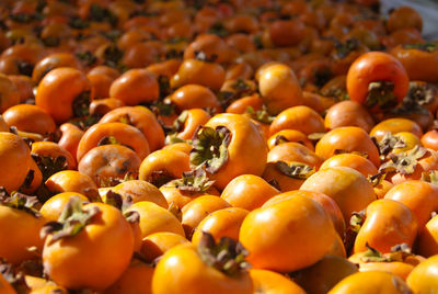 Full frame shot of yellow persimmons for sale at market stall
