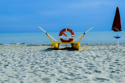 Lifeguard hut on beach against sky