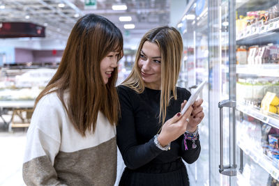 Portrait of young woman using mobile phone