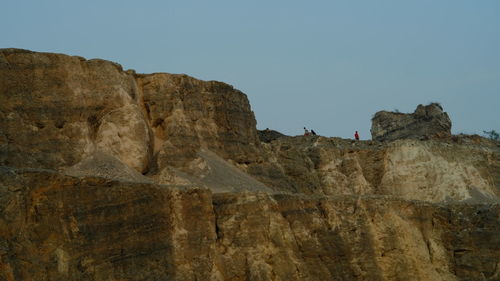 Low angle view of rock formation against clear sky