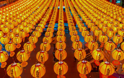 Illuminated lanterns hanging in row