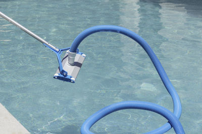 Close up view of automatic swimming pool cleaner before entering the water with water background