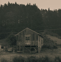 Built structure on field against trees