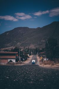 Road amidst buildings against sky in city