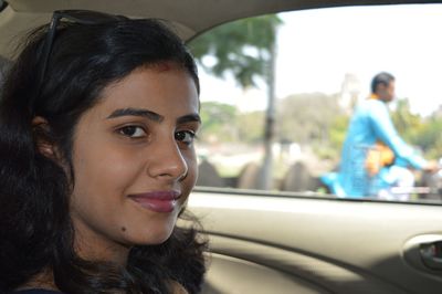 Portrait of smiling young woman in car