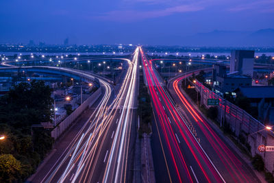 High angle view of light trails on the highway at night