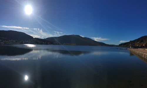 Scenic view of lake against blue sky