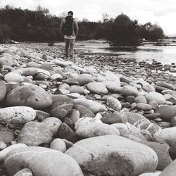 Full length of woman standing on pebbles