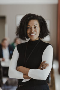 Portrait of businesswoman with arms crossed in office