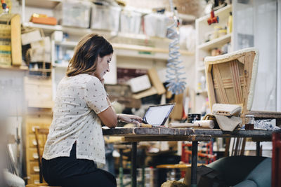 Woman working at desk in store