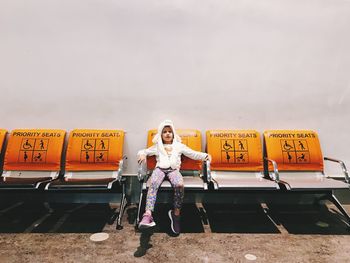 Full length portrait of woman standing on bus