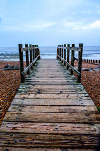 Pier over sea against sky