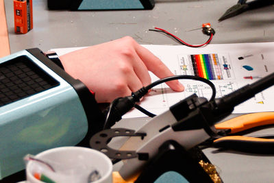 Close-up of hand using laptop on table