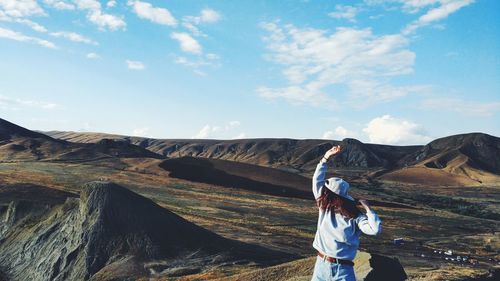 Man standing on mountain against sky