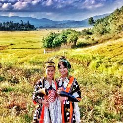 Scenic view of grassy field against sky