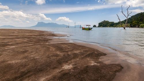 View of beach against cloudy sky